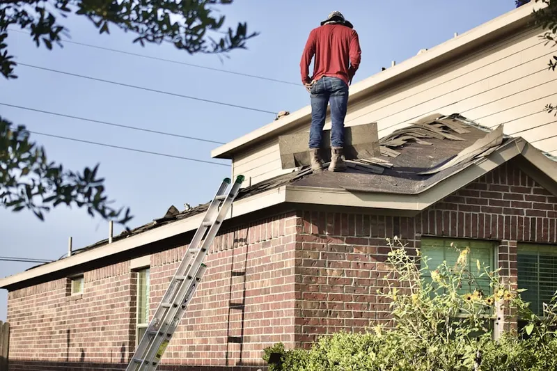 Professional roofer working on a residential roof in Aptos